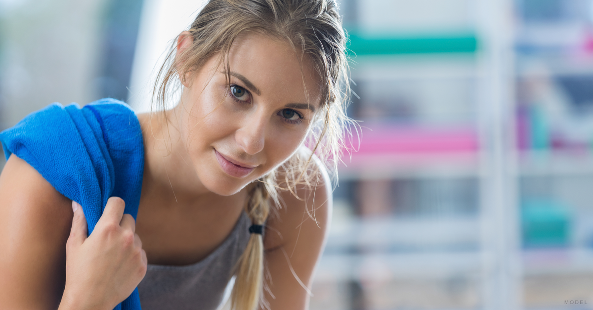 A woman who has recovered from a Mommy Makeover procedure wraps up a workout.