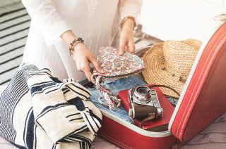 woman packing suitcase