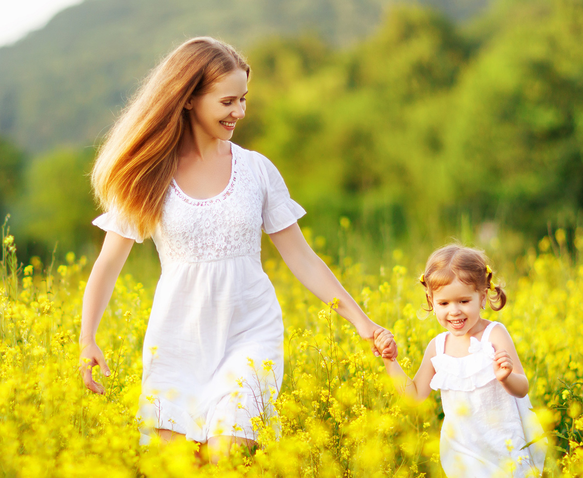 mother and toddler playing in field